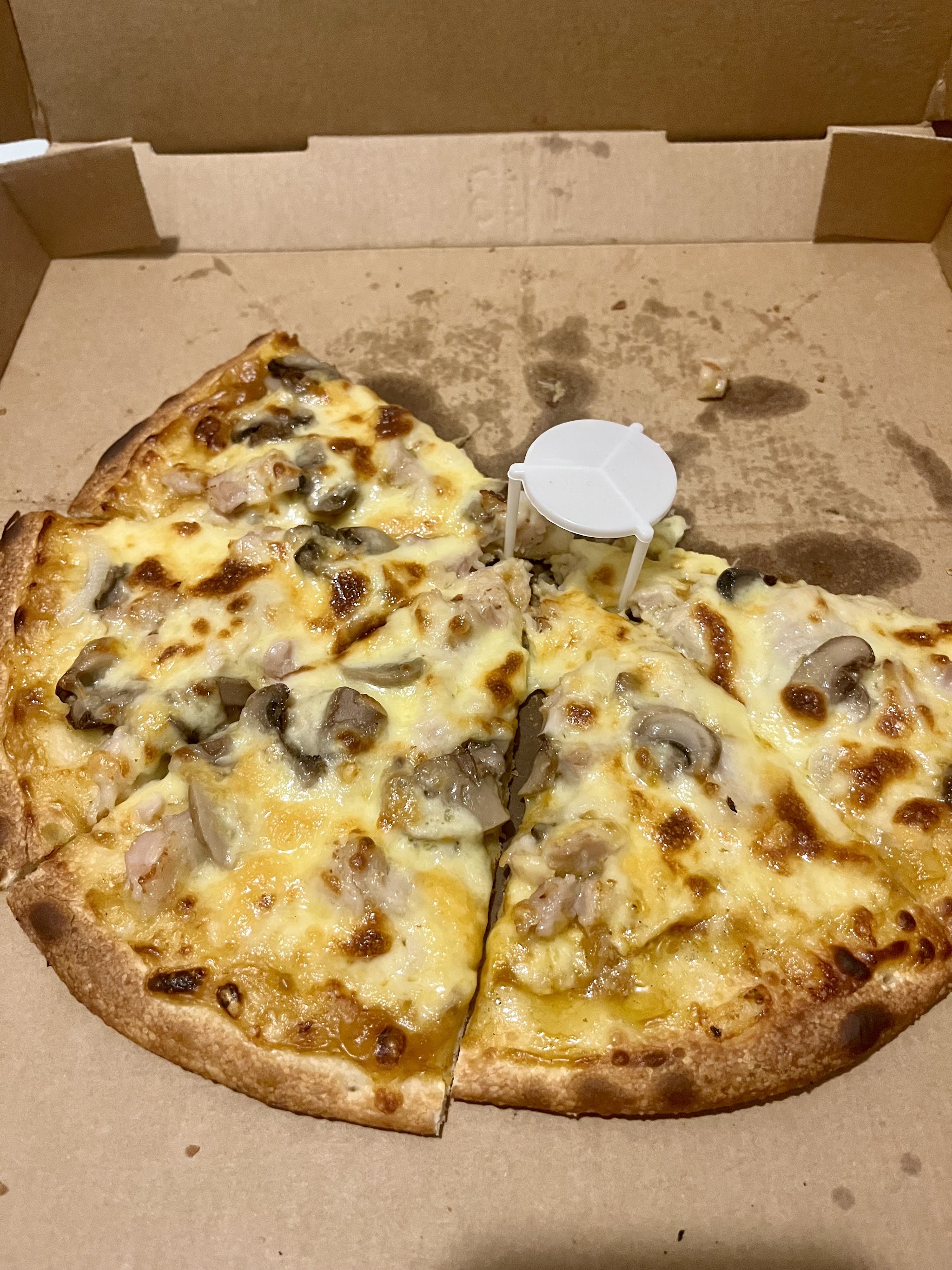 A whole Crustys pizza in the box, straight off the counter